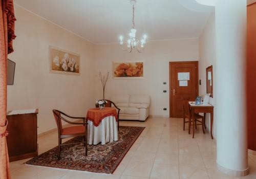 a living room with a table and a couch at San Raffaele Hotel Restaurant & Resort in Castelluccio Superiore