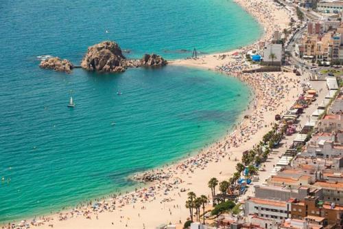 an aerial view of a beach with a bunch of people at Beta's Beach in Blanes