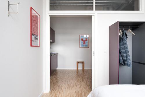 a bedroom with a door leading into a room at South Studios by Daniel&Jacob's in Copenhagen