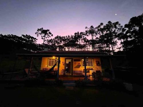 a small house with a porch at night at Cantinho da Bubu in Gonçalves