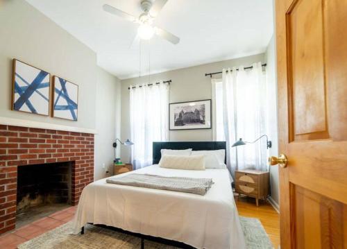 a bedroom with a bed and a brick fireplace at Casa Coquette+Near VA Hosp, MVP Arena & Law School in Albany