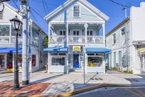 a building with blue awnings on a street at Sky Suite On Duval in Key West