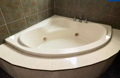 a large white bath tub in a bathroom at Hotel Real Santa Rosa in Morelia