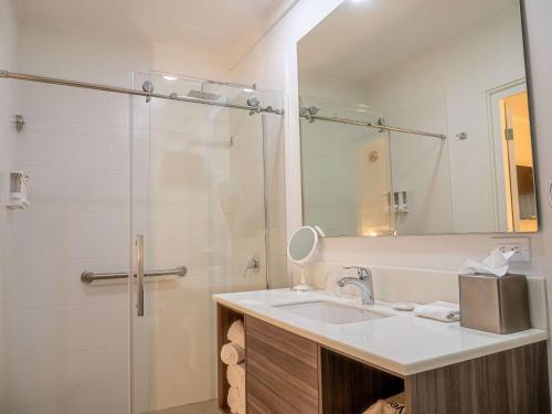 a bathroom with a sink and a shower at Aruba Boutique & Art Hotel, BW Signature Collection in Palm-Eagle Beach