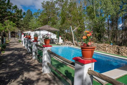 una piscina con piante in vaso su una recinzione di El Sosiego a Morella