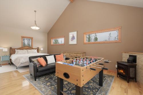 a living room with a bed and a chess board at 383 County Road 508 by Stay Winter Park in Fraser