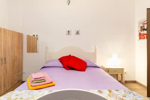 a bedroom with a bed with two towels on it at GuestHouse Pet's Friendly in Quattromiglia