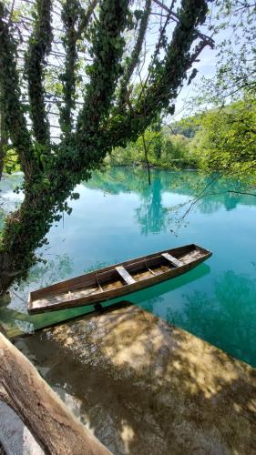 a boat sitting in the middle of a lake at Unatime.Krupa in Bosanska Krupa