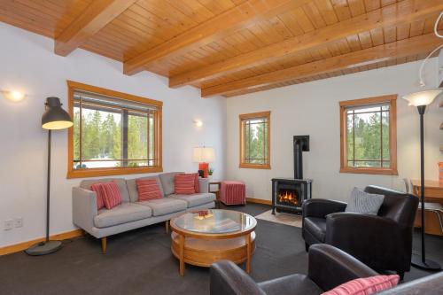 a living room with a couch and chairs and a fireplace at 383 County Road 508 by Stay Winter Park in Fraser