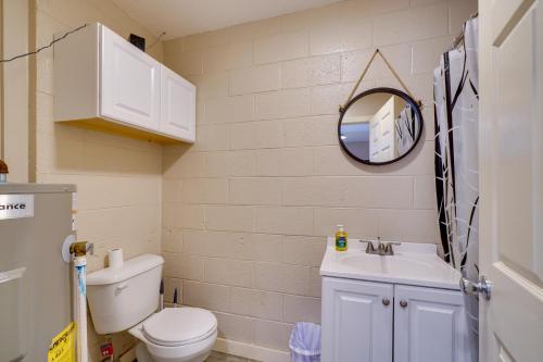 a bathroom with a toilet and a sink and a mirror at Riverfront Briceville Studio Apt ATV, Hike and More 