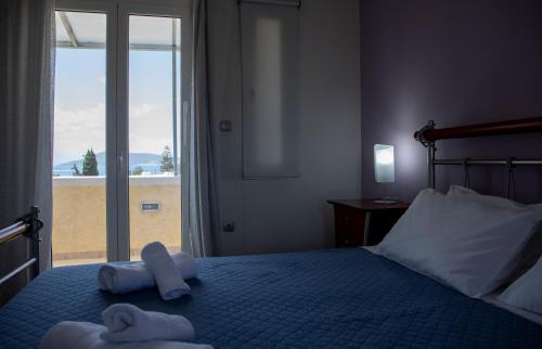 a bedroom with a bed with towels on it at The Garden House in Aegina Town