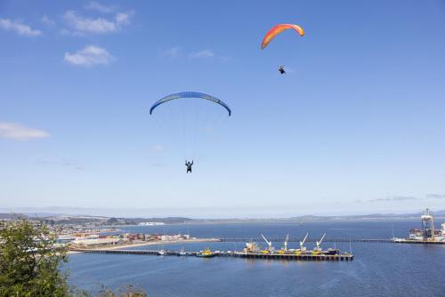 two kites flying over a large body of water at Holiday Inn Express - Concepcion by IHG in Concepción