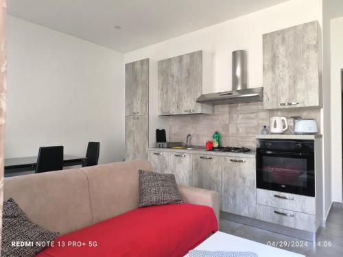 a living room with a couch and a kitchen at One bedroom TEA apartment Il-Gzira in Il-Gżira