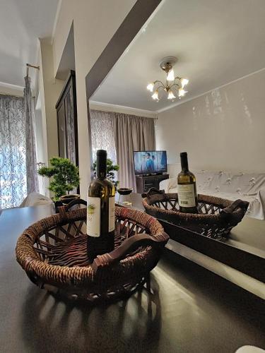 two bottles of wine sitting on a table in a living room at Ioannina Urban Oasis with Jacuzzi in Katsikás