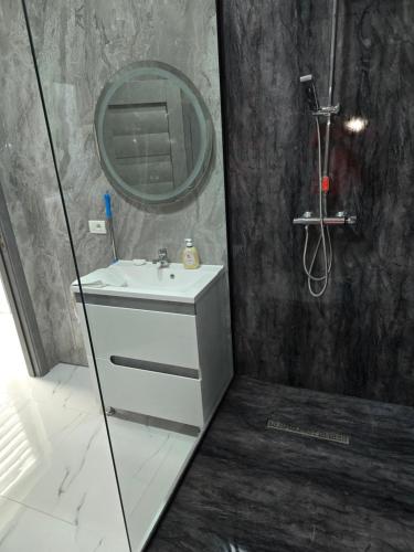 a bathroom with a sink and a mirror at Terra Residence Beiuș in Beiuş