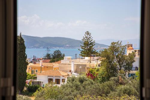 a view of a town with the ocean in the background at The Garden House in Aegina Town
