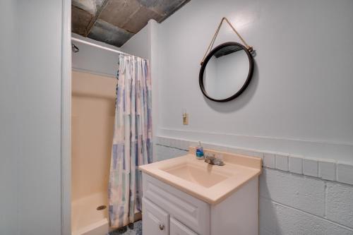 a bathroom with a sink and a mirror at Tennessee Riverside Retreat Shared Fire Pit! 