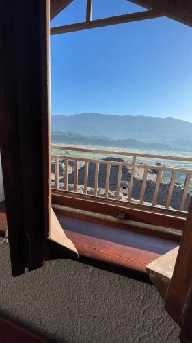 a view of the ocean from a window at Denis GuestHouse 1930 in Gjirokastër