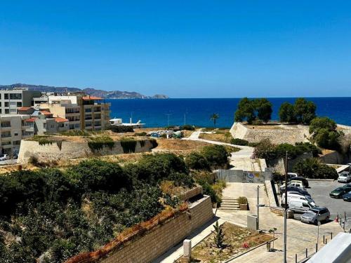 a view of a parking lot and the ocean at Nanas luxury and cozy apartment in Thérissos