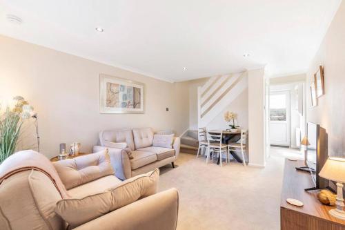 a living room with a couch and a table at 'The Cobbles' - central, stylish, garden, views in Skipton
