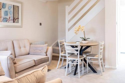 a living room with a couch and a table at 'The Cobbles' - central, stylish, garden, views in Skipton