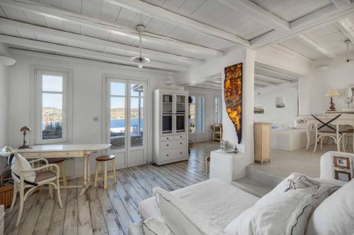 a white room with a bed and a desk at Samanti House, Leivadi Serifos in Livadi