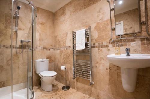 a bathroom with a toilet and a sink and a shower at Stones Throw in Scarborough