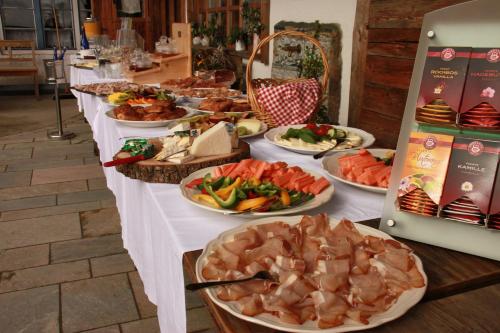 a buffet of food on a table with plates of food at Schönblick Hohenbogen in Neukirchen beim Heiligen Blut