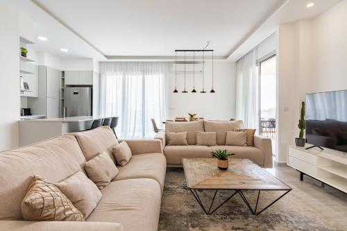 een woonkamer met een bank en een tafel bij YAMAS Urban Living Pool Penthouse Marvel in Limassol