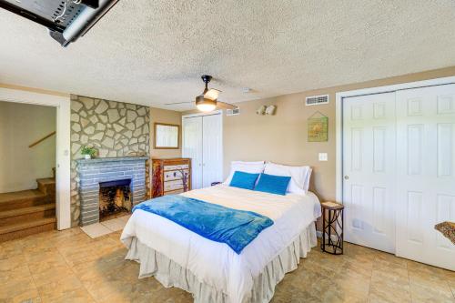 ein Schlafzimmer mit einem Bett und einem Kamin in der Unterkunft Kingsport Boone Lake Hideaway with Deck and Views! in Kingsport