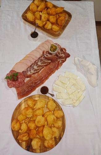 a table topped with plates of food on a table at Omni S Apartments in Bar