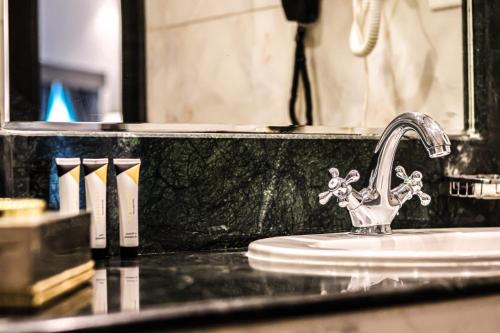 a bathroom counter with a sink with a faucet at Odst Jeddah in Jeddah