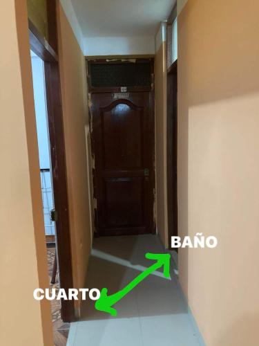 a room with a door and a arrow pointing to a corridor at Thiago MG in Chiclayo