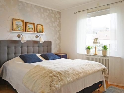 a bedroom with a large bed and a window at Holiday home LYSEKIL XXXII in Lysekil