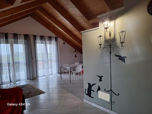 a living room with a lamp with bats on the wall at Casa Matilde in Leinì