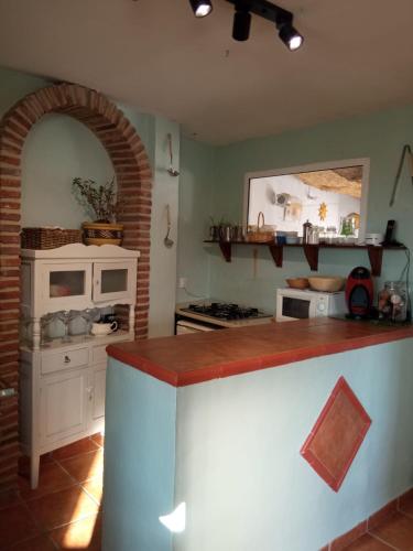 a kitchen with a counter top and a stove top oven at Hostal R-Conecta in Cuevas de San Marcos
