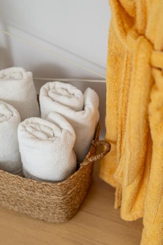 a basket filled with white towels on a table at Villa Kalliopi ΙnCreteble Cretan Resindences Collection in Xerokampos
