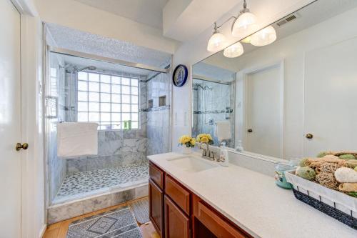 a bathroom with a shower and a sink and a mirror at Cozy 3 bedrooms home with indoor fireplace in Houston
