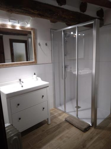 a bathroom with a glass shower and a sink at Lo Cremallé in Valderrobres