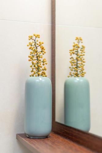 a blue vase sitting on a shelf next to a mirror at Villa Kalliopi ΙnCreteble Cretan Resindences Collection in Xerokampos