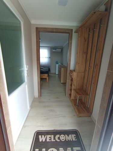 a hallway with a welcome rug on the floor at Family House in Makarovka