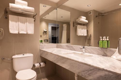 a bathroom with a sink and a toilet and a mirror at Holiday Inn Express - Iquique by IHG in Iquique