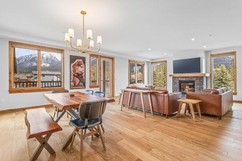 a living room with a table and chairs and a fireplace at Spring Creek Vacations in Canmore