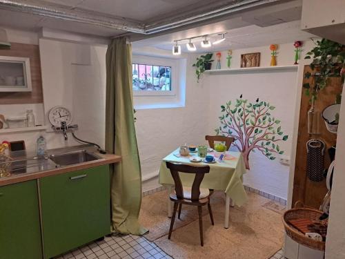 a kitchen with a table and a small table and a sink at Lianes Feriendomizil Fewo in Niedernjesa - Friedland in Friedland