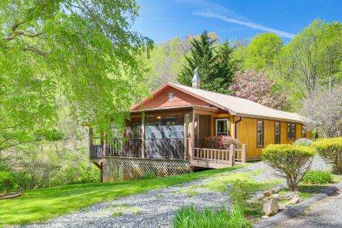 a home with a large porch and a house at Peaceful Mars Hill Home with Porch and Mountain Views in Mars Hill