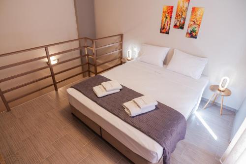 a bedroom with a bed with two towels on it at Amaryllis Maison Viziis in Alexandroupoli