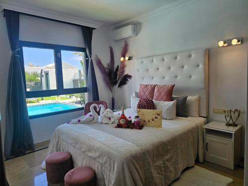 a bedroom with a large bed with a large window at VILLA KARLA in Playa Blanca