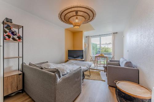 un salon avec deux chaises et un canapé dans l'établissement Appartement Chanzy - Welkeys, à Arcachon