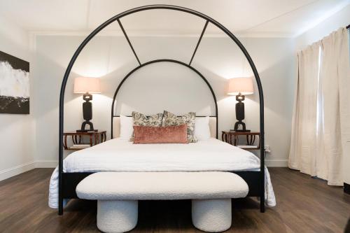 an arched bed in a bedroom with two lamps at Inn of Chagrin in Chagrin Falls