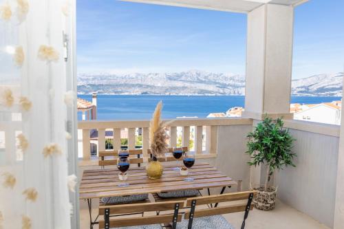 a table on a balcony with a view of the ocean at Holiday house Mila in Postira